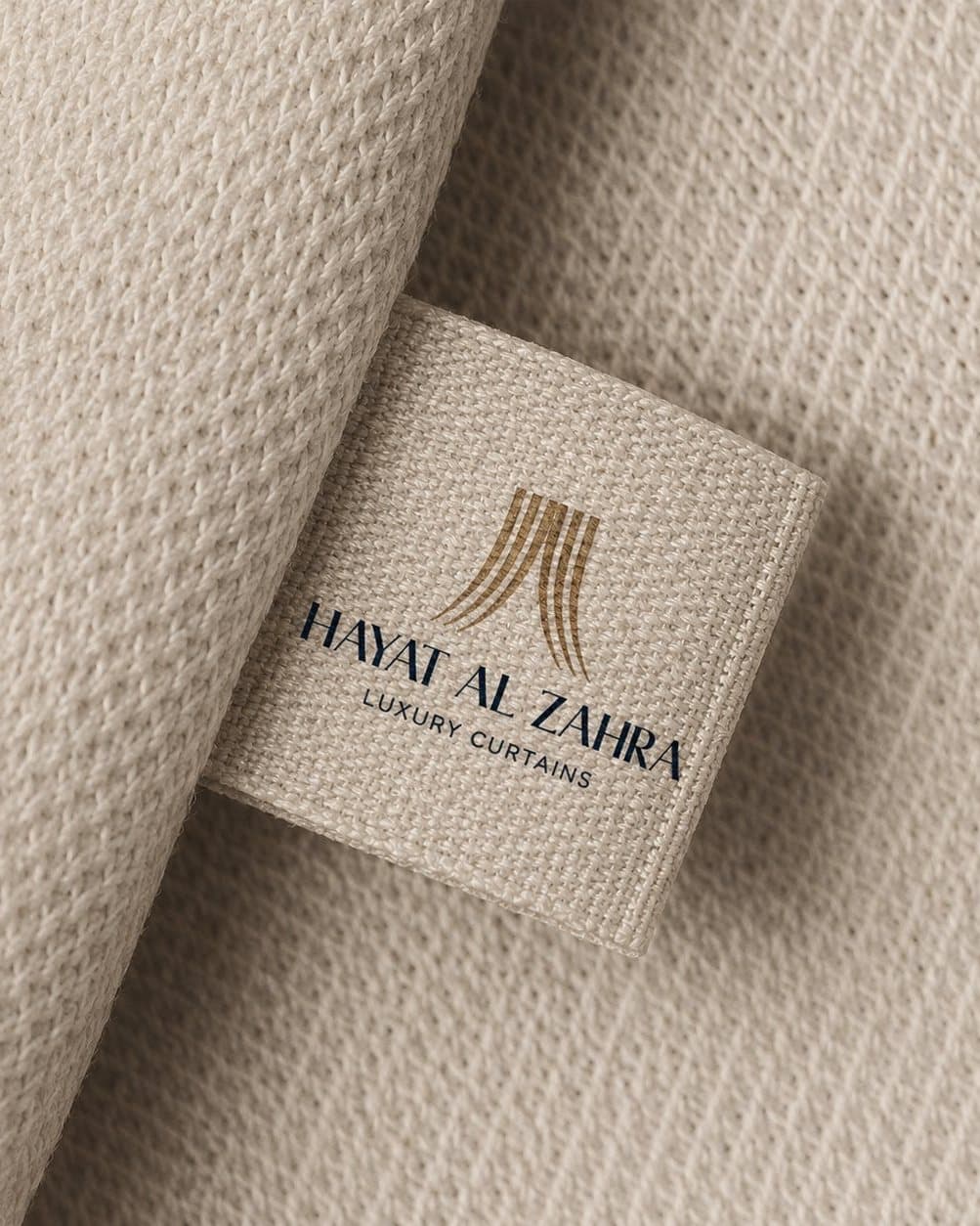 Woven Hayat Al Zahra label on ivory fabric